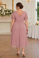 Back view of plus size pink polka dot midi dress featuring a V-back neckline, short sleeves and A-line silhouette.