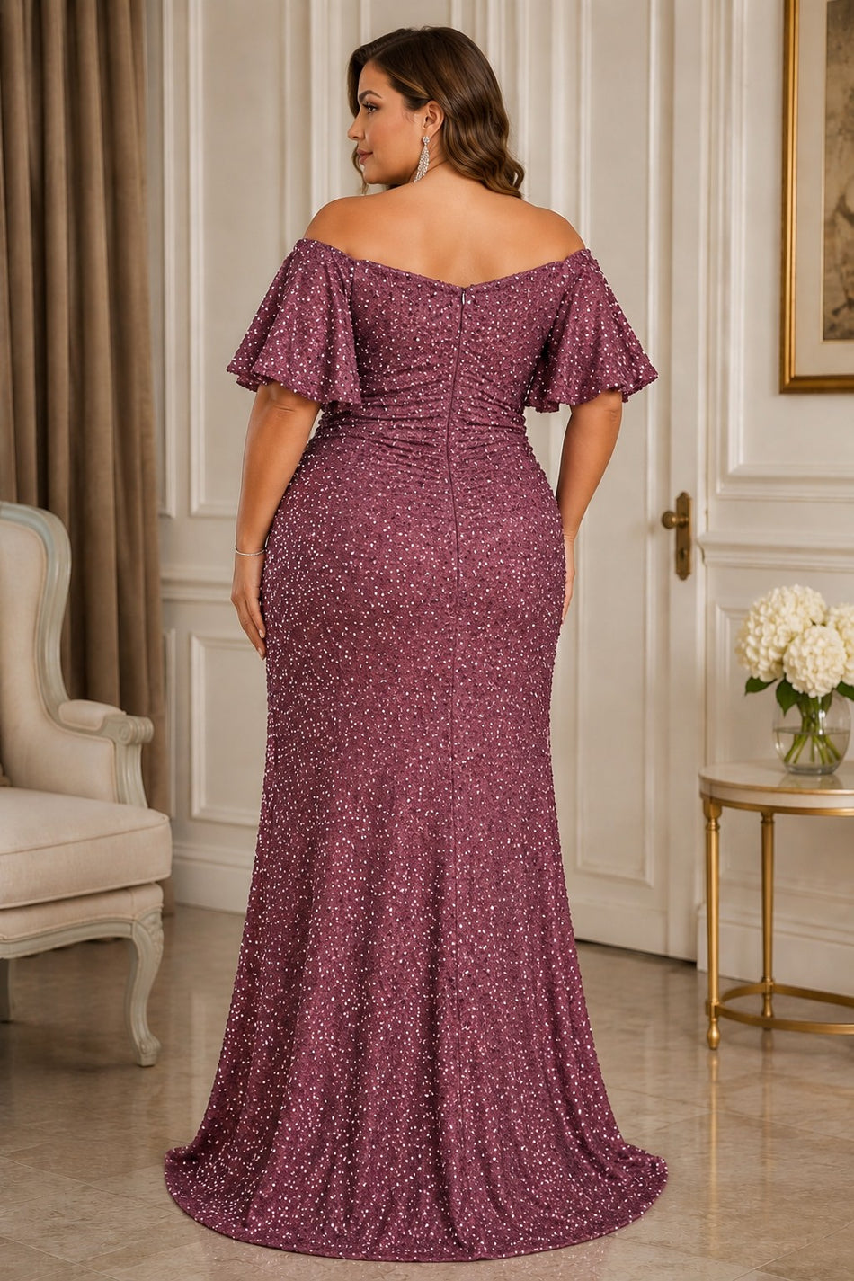 Back ALT Text
Back view of a plus size pink sequin formal maxi dress with off-shoulder neckline, flutter sleeves, fitted silhouette and gently flared floor-length hem.