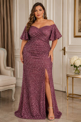 Plus size woman wearing a pink sequin formal maxi dress with off-shoulder neckline, flutter sleeves, wrap-style draped bodice and front thigh split.