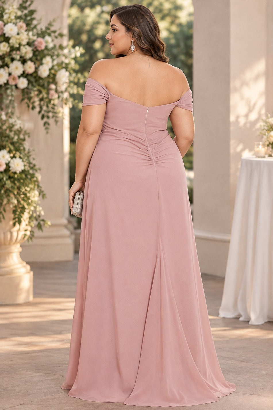 Back view of a dusty pink off-shoulder maxi dress with short draped sleeves and a flowing full-length skirt.