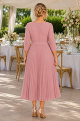 Plus size pleated midi wedding guest dress with 3/4 sleeves and wrap V-neckline in dusty pink