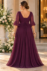 Back view of a purple chiffon formal maxi dress with 3/4 flutter sleeves and flowing floor-length skirt.