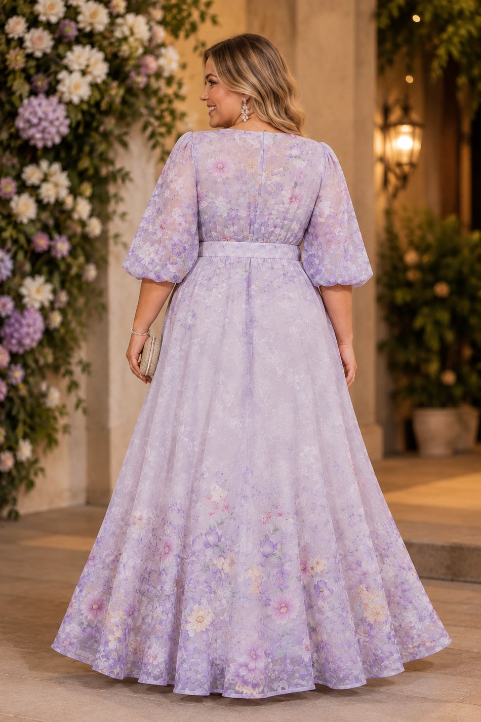Back view of a purple floral plus size maxi dress with elbow-length sleeves, defined waist and flowing A-line skirt.