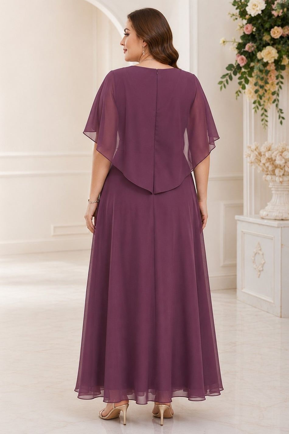 Back view of a plus size purple maxi formal dress with flowing cape overlay and full-length A-line skirt.