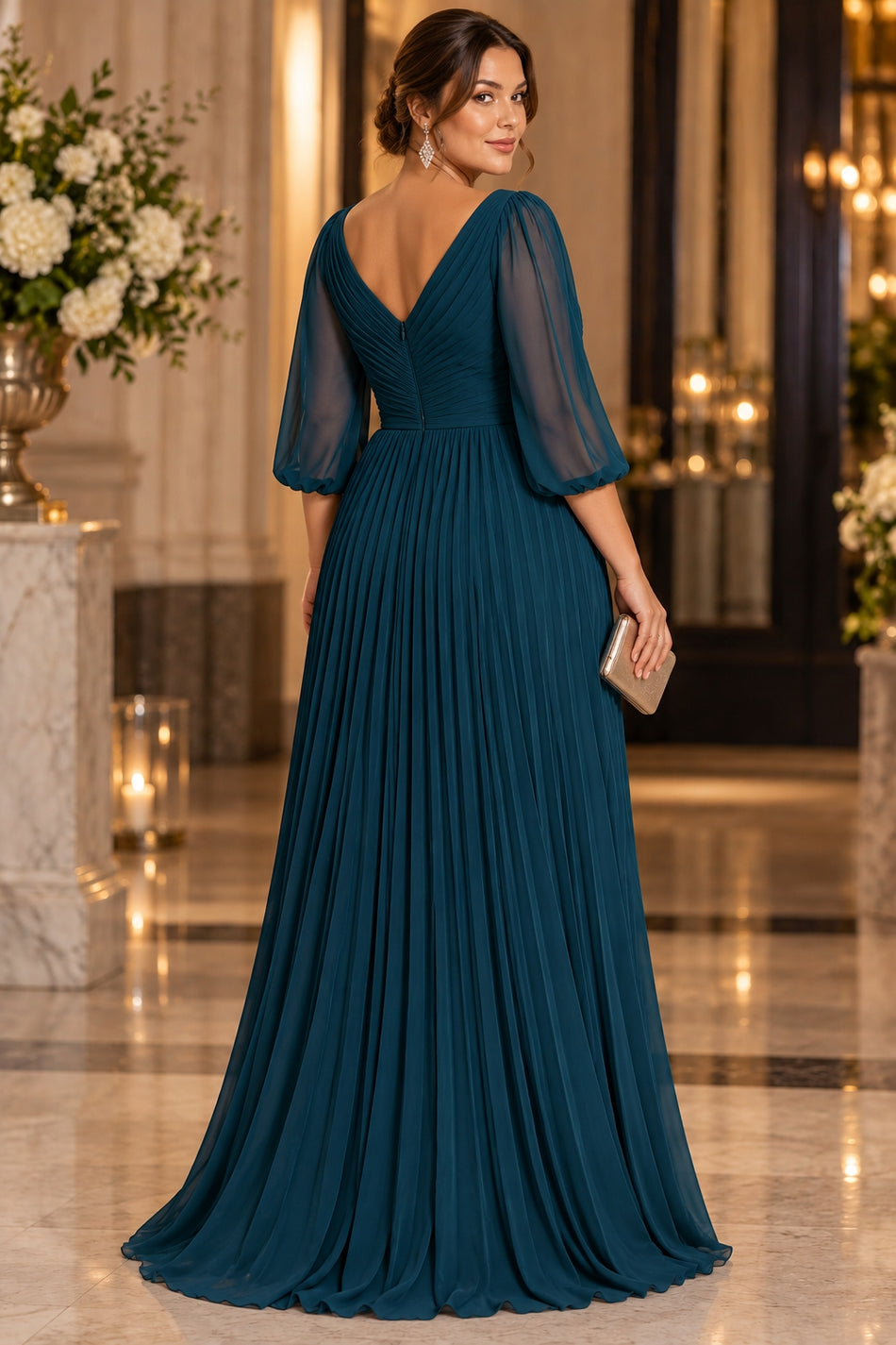 Back view of a teal maxi evening dress with V-shaped back, sheer three-quarter sleeves and flowing full-length skirt.