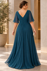 Back view of plus size teal formal dress with flutter sleeves and full-length flowing skirt.