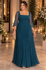 Woman wearing a teal plus size formal dress with sheer three-quarter sleeves, a square neckline and pleated maxi skirt.