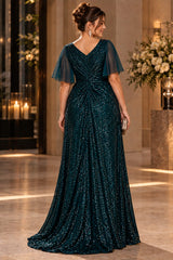 Back view of a plus size dark teal sequin evening maxi dress with a V-shaped back neckline, sheer flutter sleeves and gathered draping.