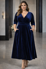 Plus Size Velvet Wrap Midi Dress in deep navy velvet, suitable for wedding guests and evening events