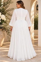 Back view of a plus size white long sleeve maxi dress with lace-up waist detail and flowing floor-length skirt.