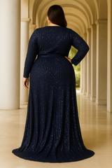 Back view of a wearing a plus size navy blue sequin gown with a high slit