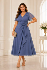 Plus size wrap midi dress with flutter sleeves, waist tie and flowing A-line skirt in dusty blue.